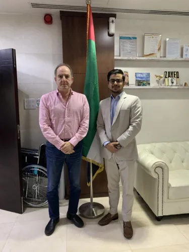 Taha Munir with a client at the office